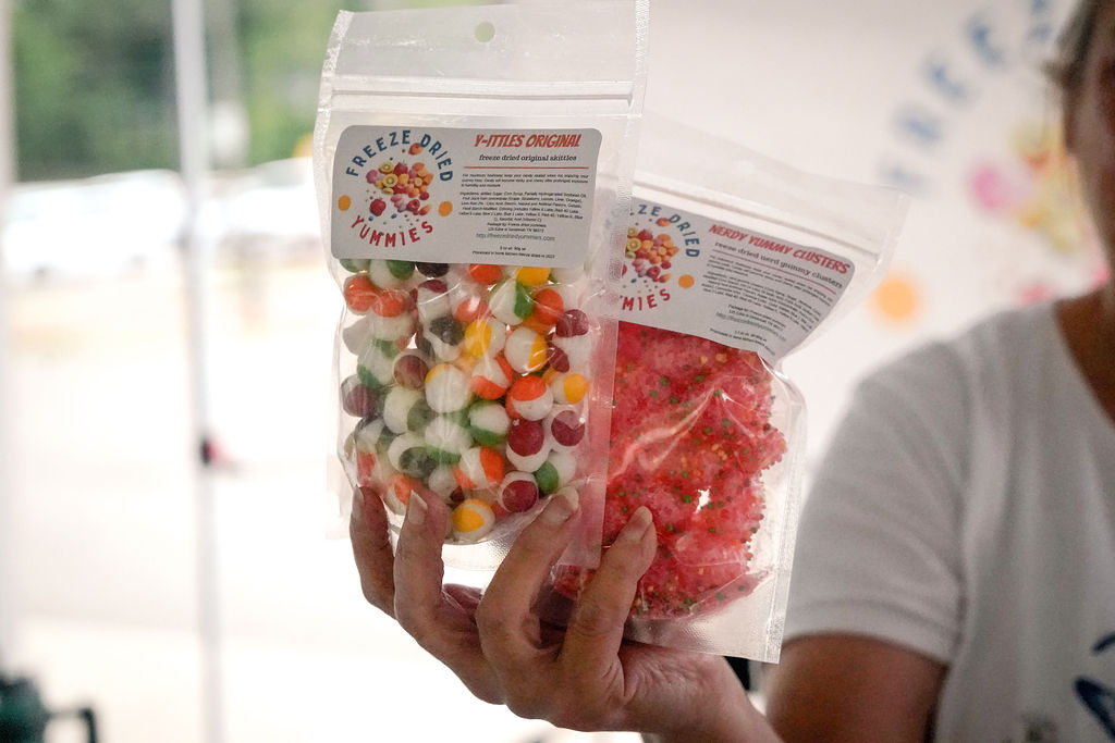 woman holding bags of freeze dried candy